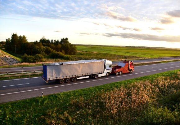 Heavy,recovery,truck,tows,a,semitrailer,truck,on,highway.,emergency